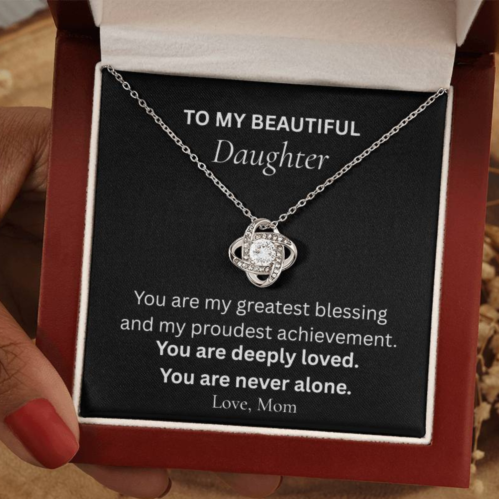 Love Knot necklace for daughter from mom displayed in luxury gift box with heartfelt message