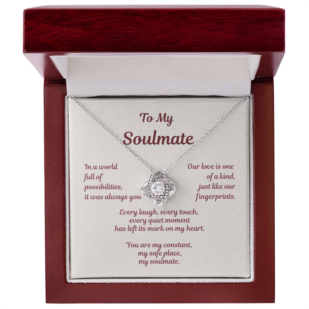 Love knot necklace displayed in gift box with soulmate message card reading In a world full of possibilities our love was inevitable.