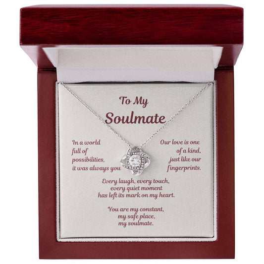 Love knot necklace displayed in gift box with soulmate message card reading In a world full of possibilities our love was inevitable.