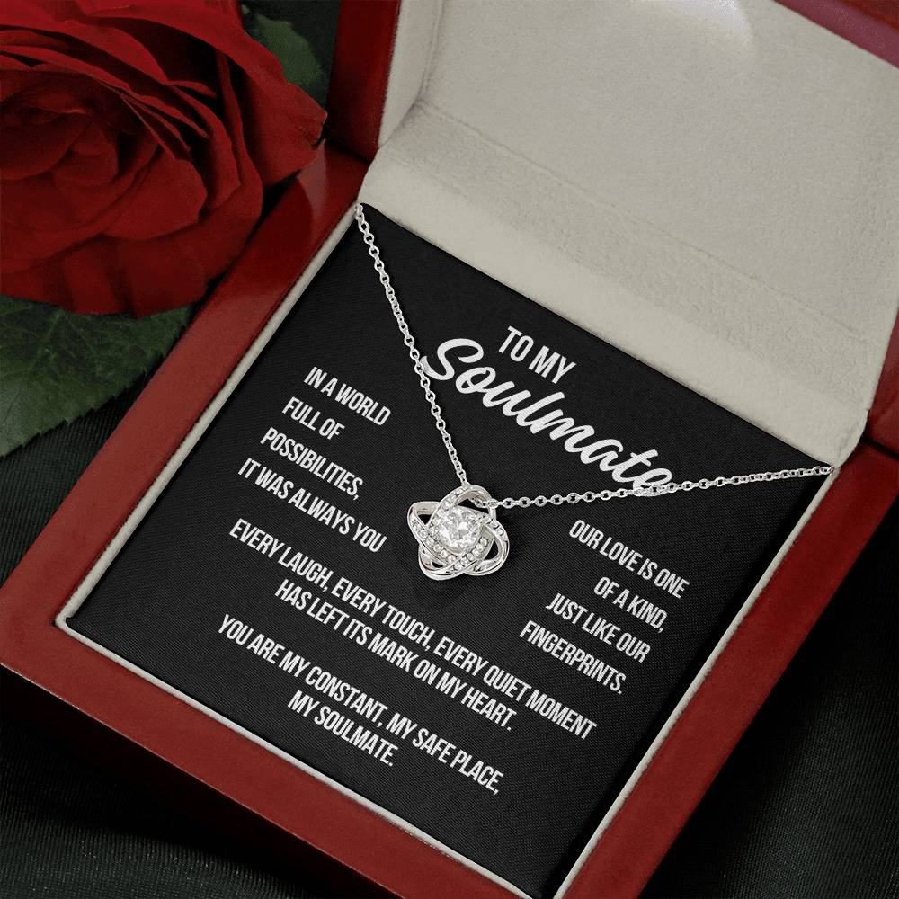 Open gift box showing white gold Love Knot Necklace with black soulmate message card
