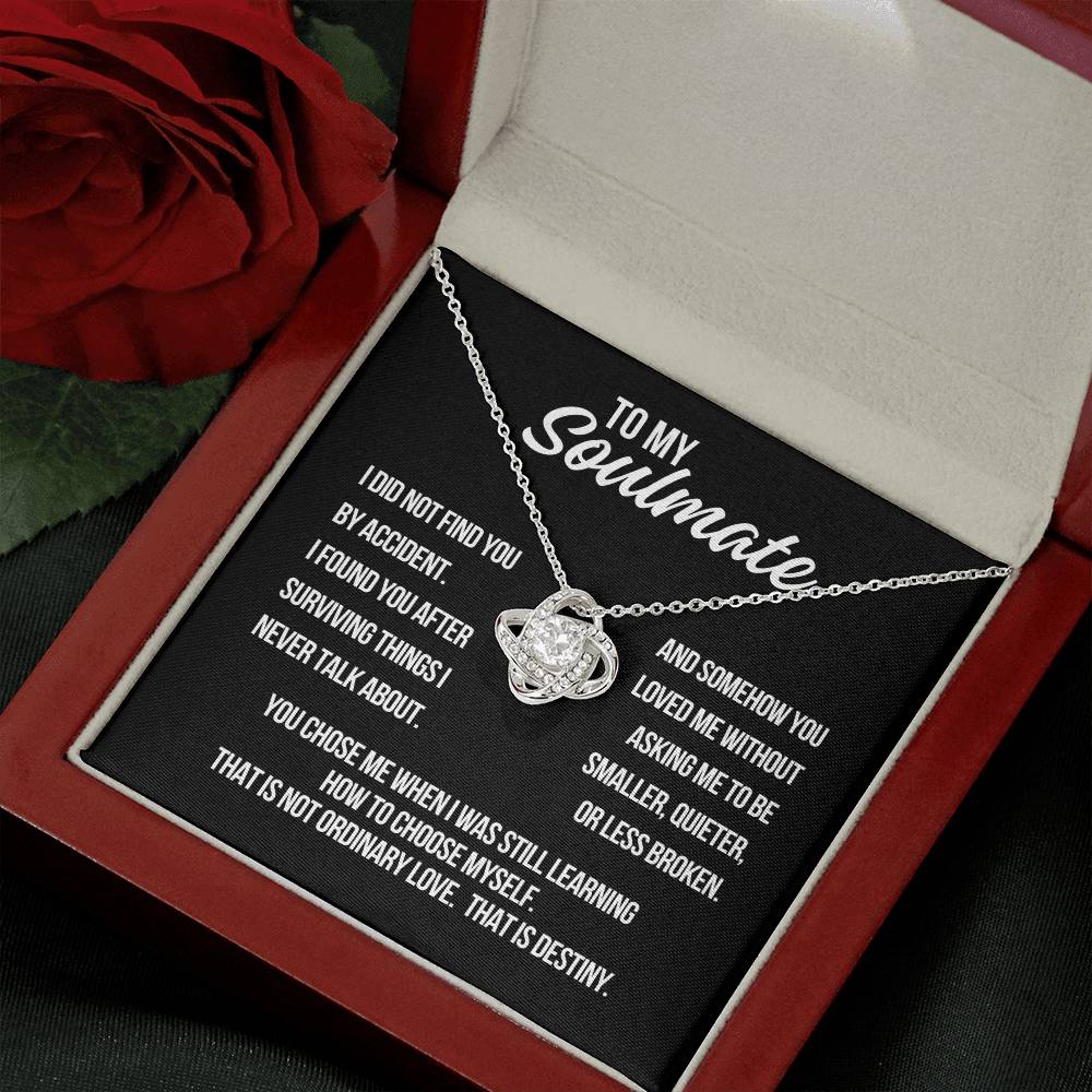 Angled view of To My Soulmate Love Knot Necklace in white gold with black background destiny message card