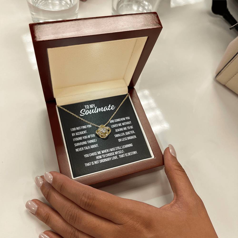 Hand holding To My Soulmate Love Knot Necklace gift box featuring black background destiny message card