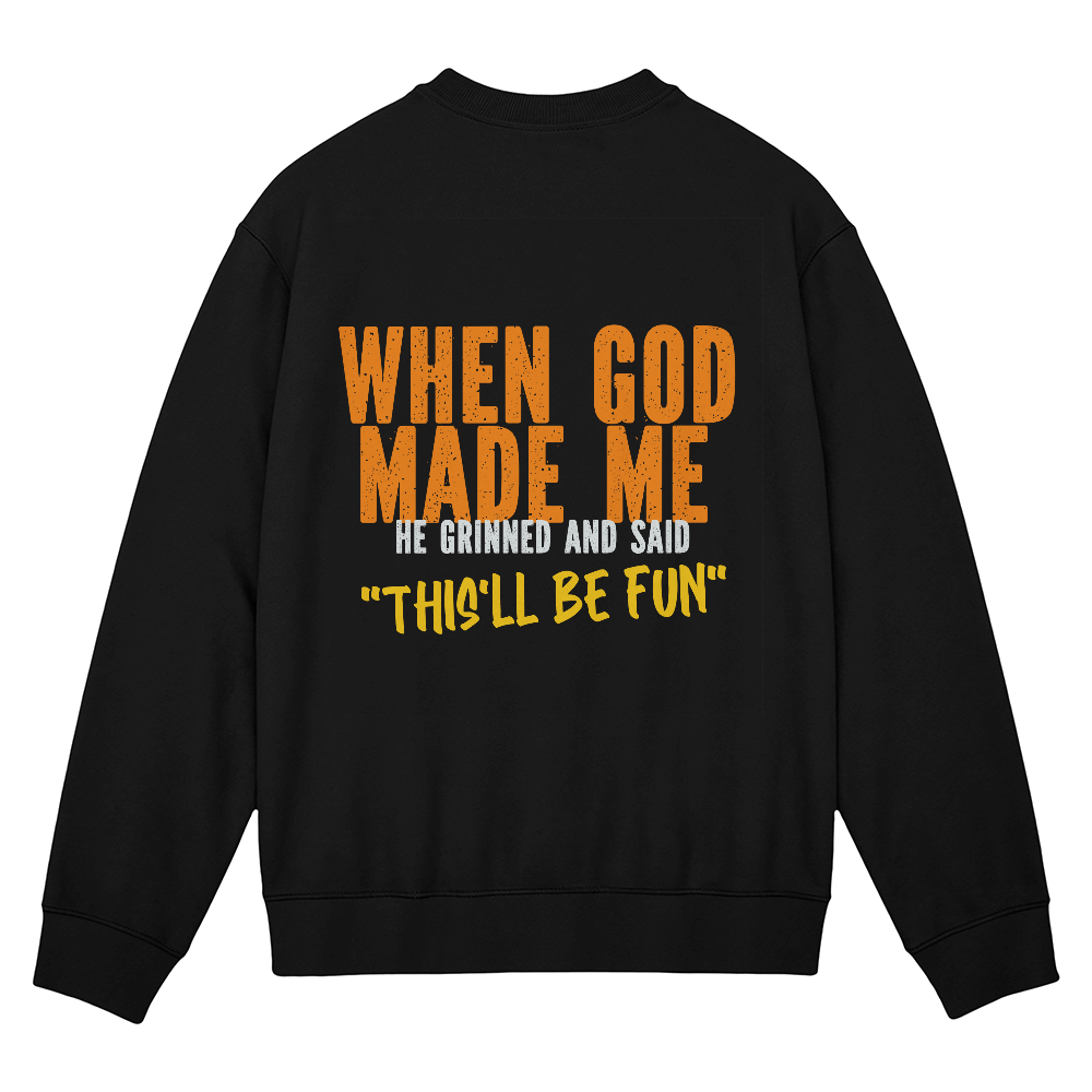 Black unisex crewneck sweatshirt featuring orange lettering with the faith and humor message When God Made Me He Grinned and Said This’ll Be Fun